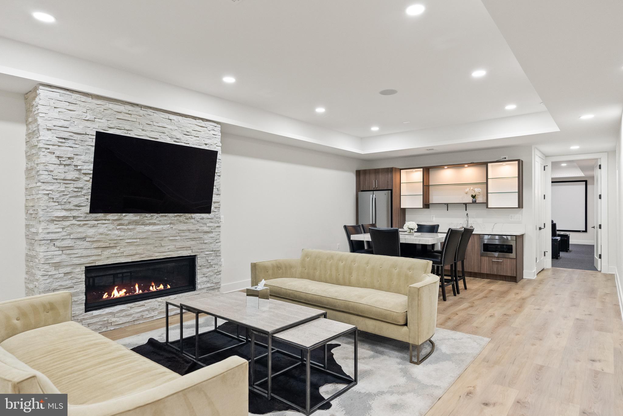 8100 Lewinsville Road McLean, VA 22102 - Photo 41 of 49 a living room with furniture a fireplace and a flat screen tv