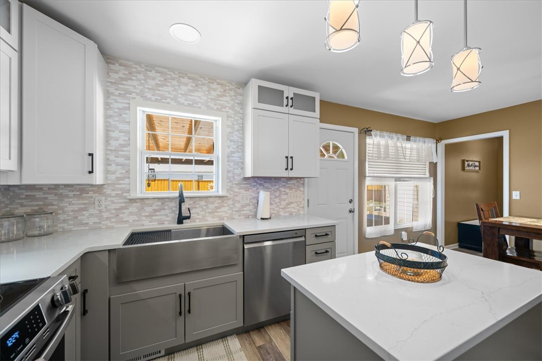 623 New Hope Road Anderson, SC 29626 - Photo 9 of 49 Gleaming stone countertops and a modern apron sink anchor this beautifully updated workspace.