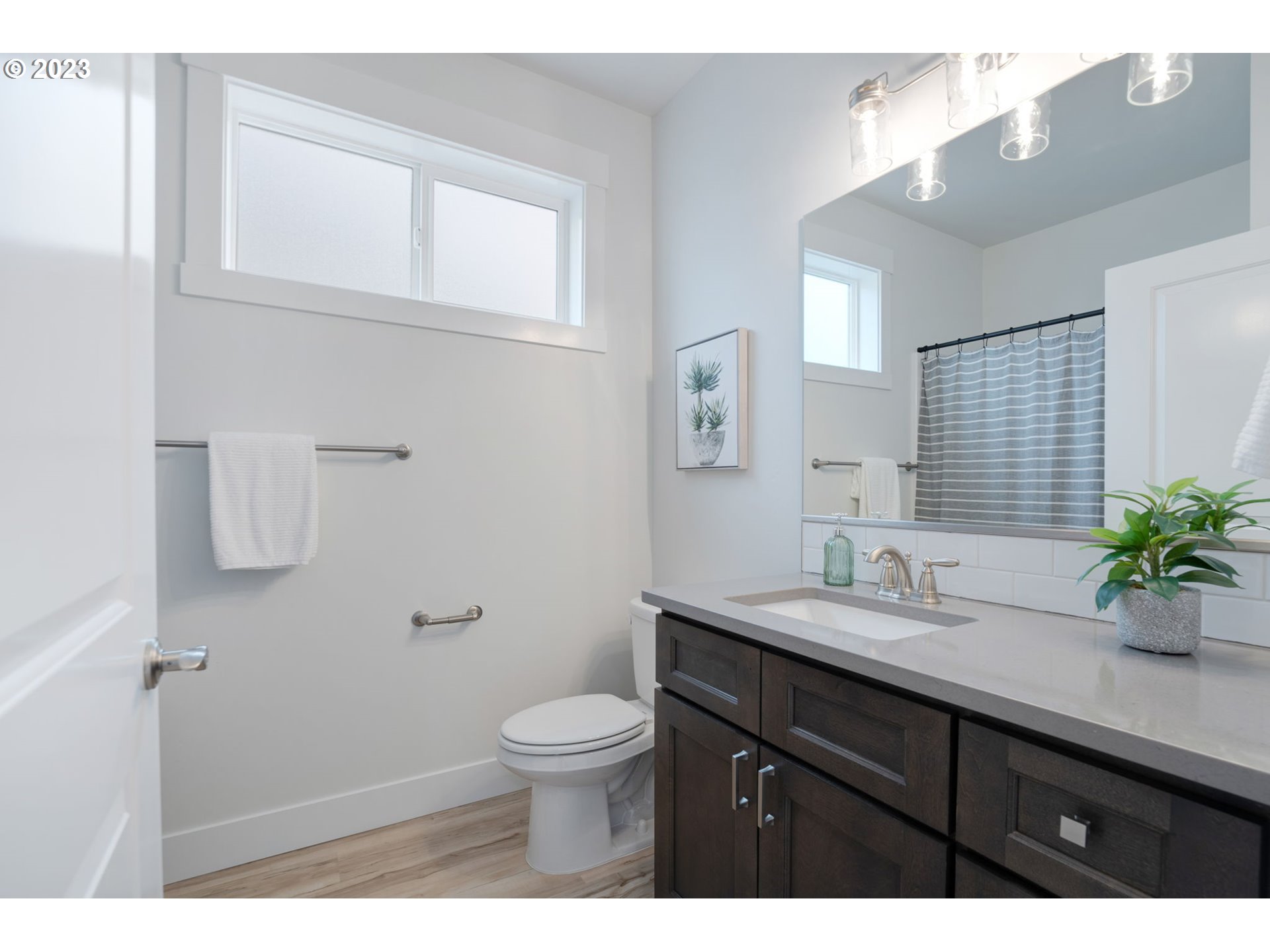 318 Sage Street Boardman, OR 97818 - Photo 5 of 20 a bathroom with a granite countertop sink a toilet and mirror
