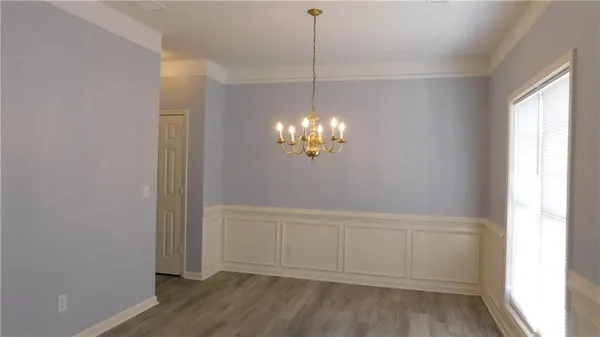 a view of a chandelier fan and wooden floor