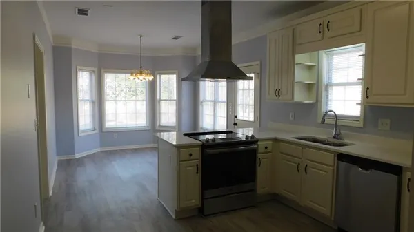 a kitchen with a sink stove and cabinets