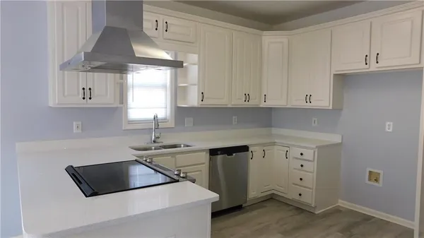 a kitchen with granite countertop a sink stainless steel appliances and cabinets
