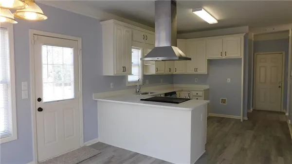 a kitchen with a stove a sink and a refrigerator