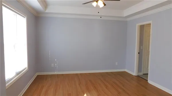 an empty room with a hardwood and a window