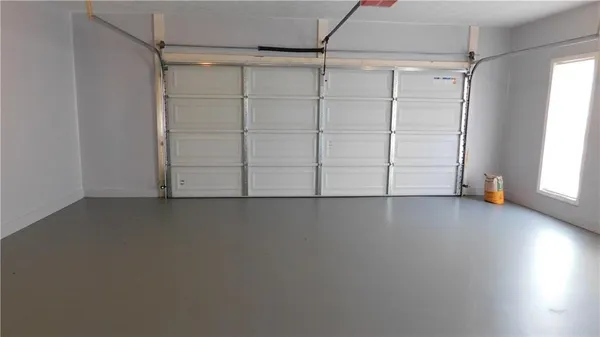 an empty room with an empty space and windows