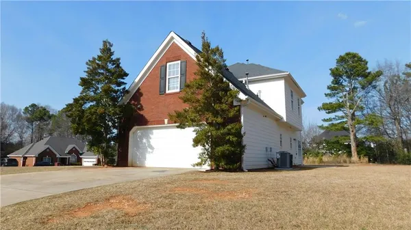 a view of a house with a yard and garage