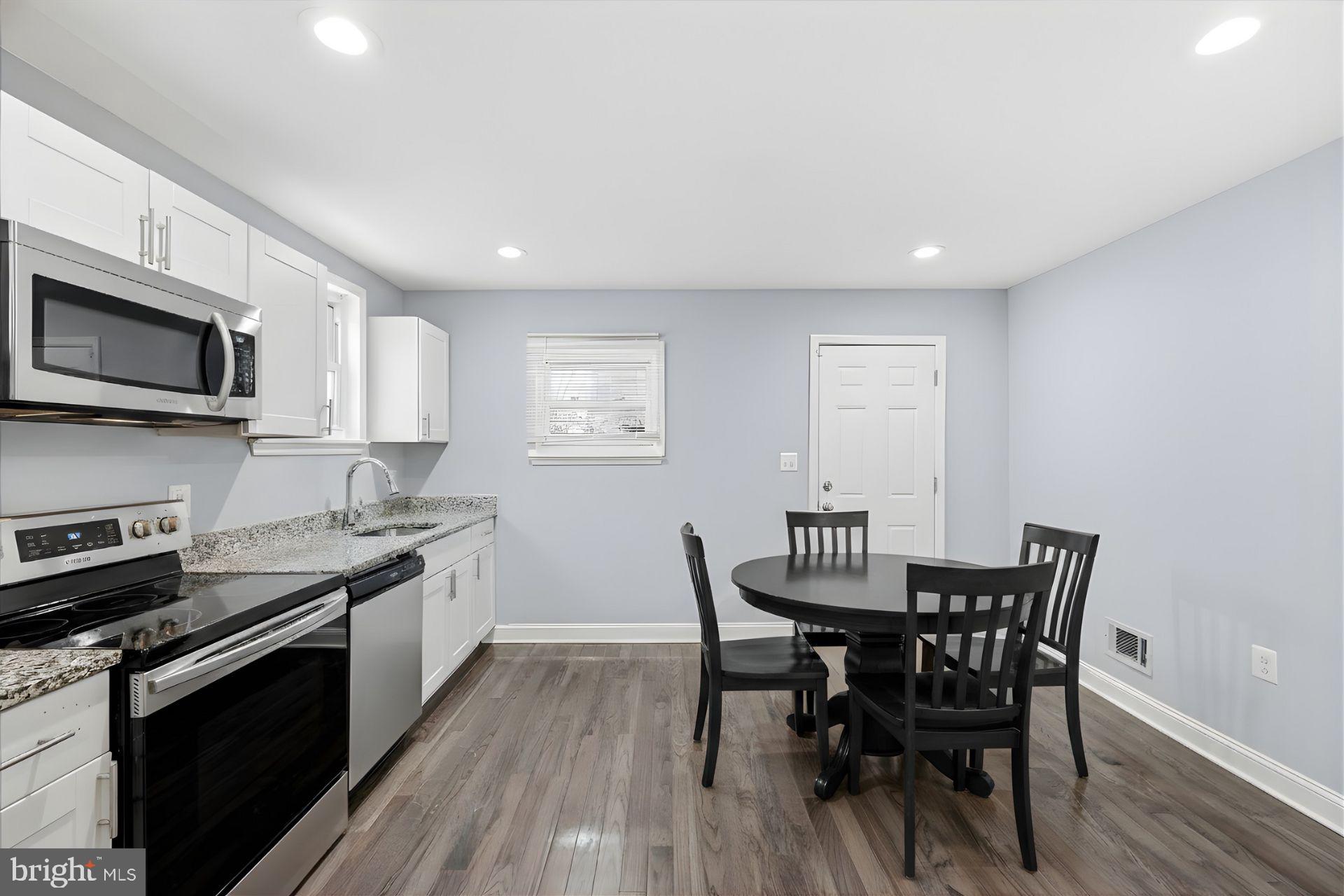 529 Mosher Street Baltimore, MD 21217 - Photo 3 of 12 a view of a dining room with furniture and wooden floor
