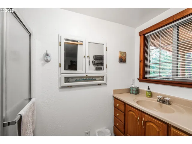 a bathroom with a sink vanity and mirror