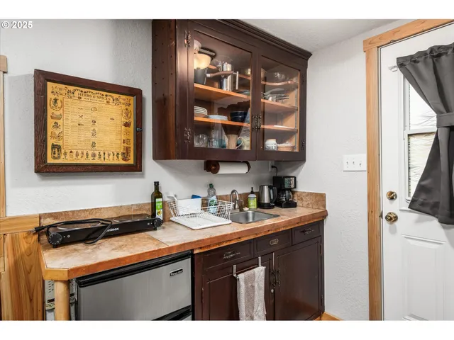 a view of bedroom with wooden floor and flat screen tv