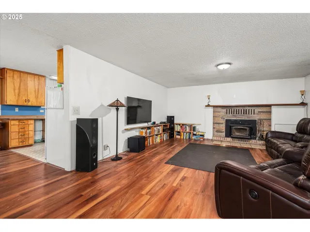 a living room with furniture a fireplace and a television