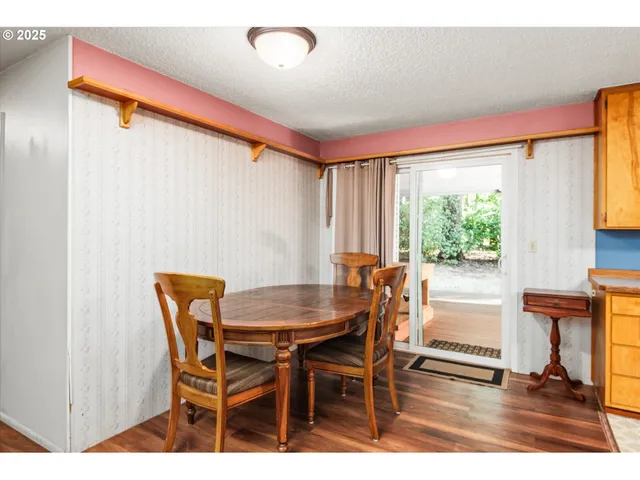 a view of a dining room with furniture and a window
