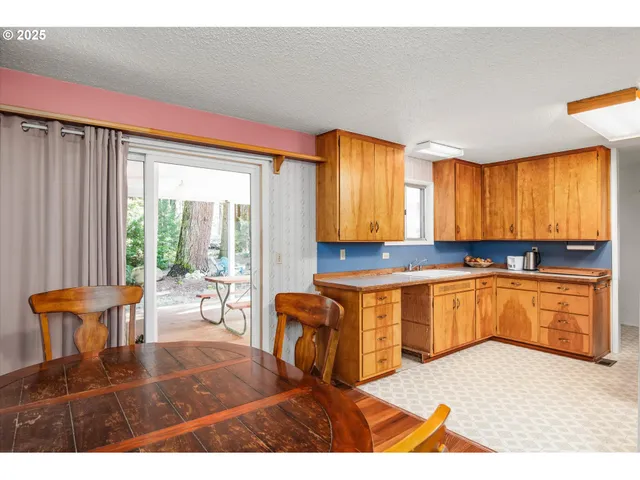 a kitchen with stainless steel appliances granite countertop a stove a sink and a granite counter top