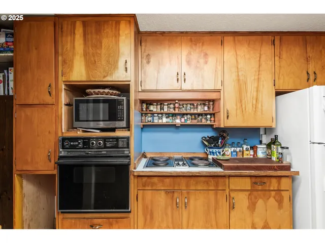 a kitchen with a stove a sink and a microwave