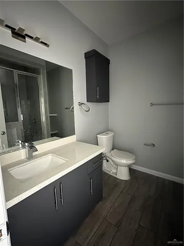 a bathroom with a double vanity sink toilet and shower