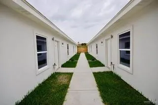 a view of a back yard with flower plants