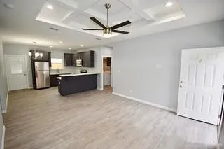 a large kitchen with stainless steel appliances granite countertop a stove and a refrigerator