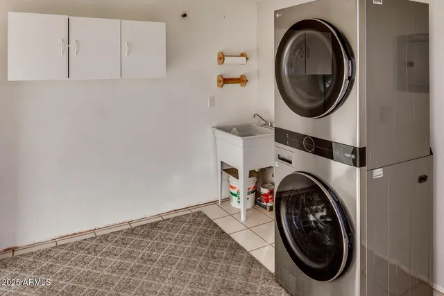 a view of a storage and utility room with washer and dryer