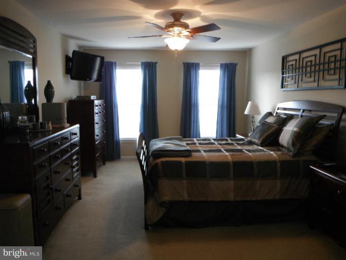 5622 New Forge Road White Marsh, MD 21162 - Photo 14 of 29 a bedroom with a bed and a chandelier