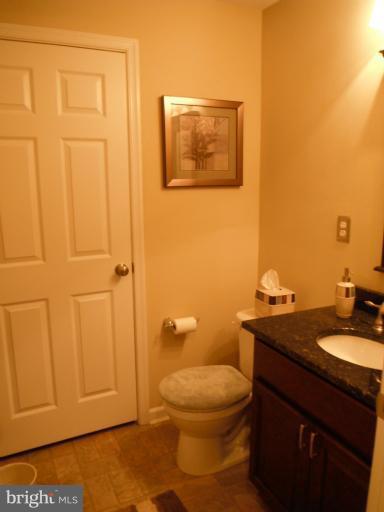 5622 New Forge Road White Marsh, MD 21162 - Photo 17 of 29 a bathroom with a granite countertop toilet and sink