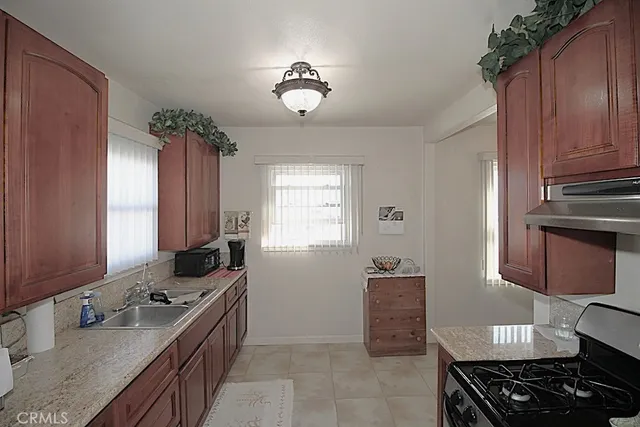 a kitchen with a sink stove and cabinets