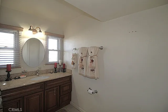 a bathroom with a double vanity sink mirror and shower