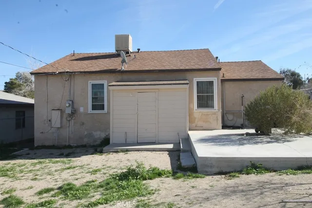 a view of a house with a yard and sitting area