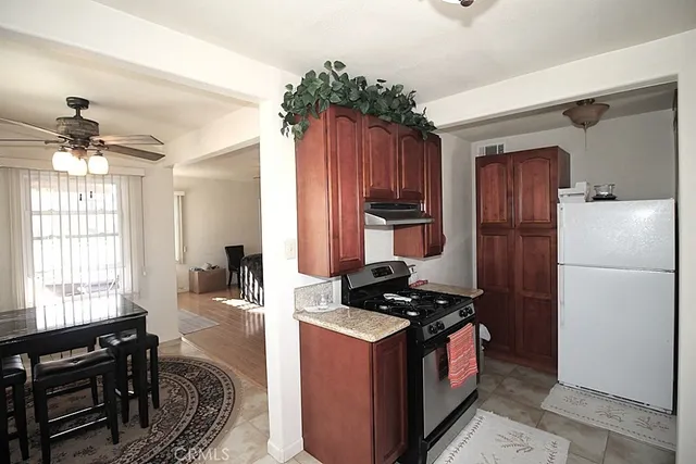 a kitchen with a refrigerator stove and a sink