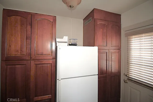 a white refrigerator freezer sitting in a kitchen