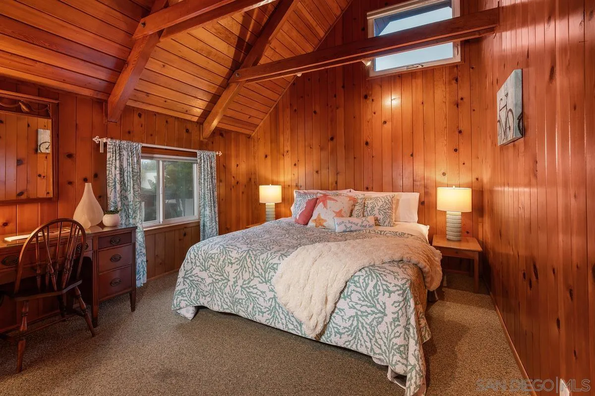 1366 Neptune Avenue Encinitas, CA 92024 - Photo 21 of 48 a bedroom with a bed and wooden floor