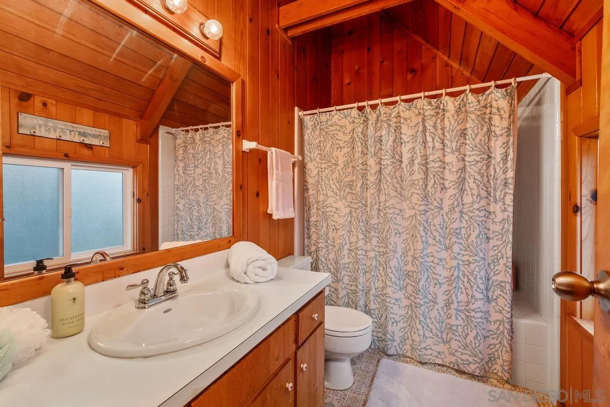 1366 Neptune Avenue Encinitas, CA 92024 - Photo 22 of 48 a bathroom with a sink and a mirror