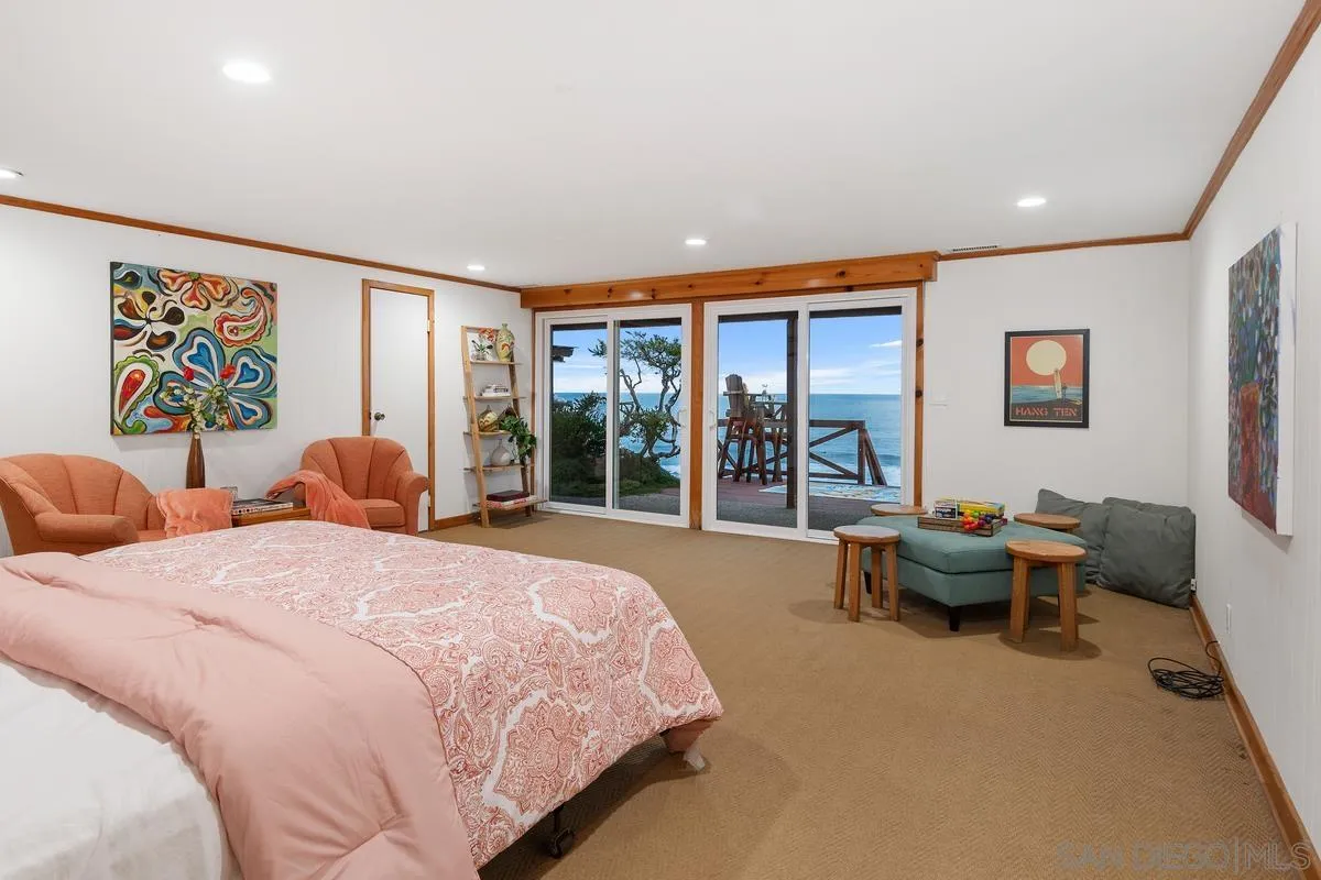 1366 Neptune Avenue Encinitas, CA 92024 - Photo 24 of 48 a bedroom with a bed and large windows