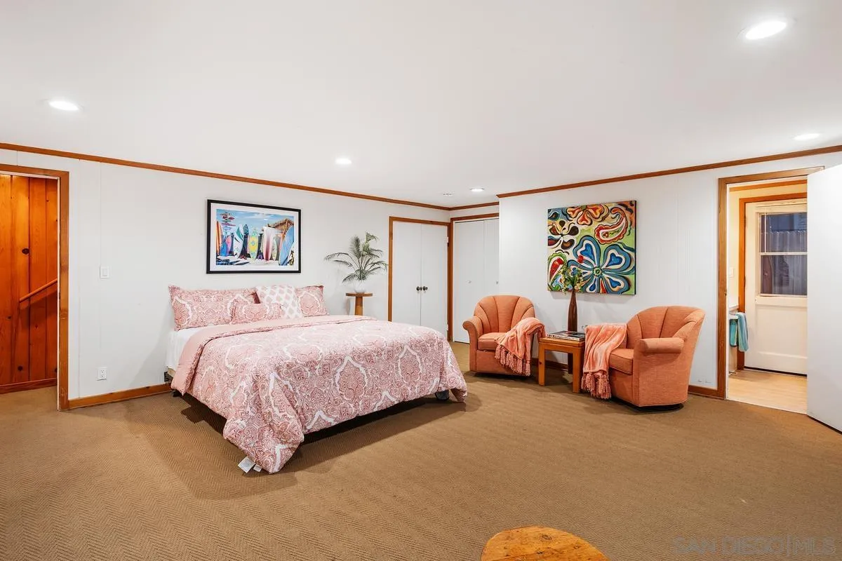 1366 Neptune Avenue Encinitas, CA 92024 - Photo 25 of 48 a spacious bedroom with a bed and a couch