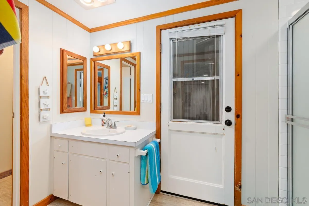 1366 Neptune Avenue Encinitas, CA 92024 - Photo 26 of 48 a bathroom with a sink a mirror and a window