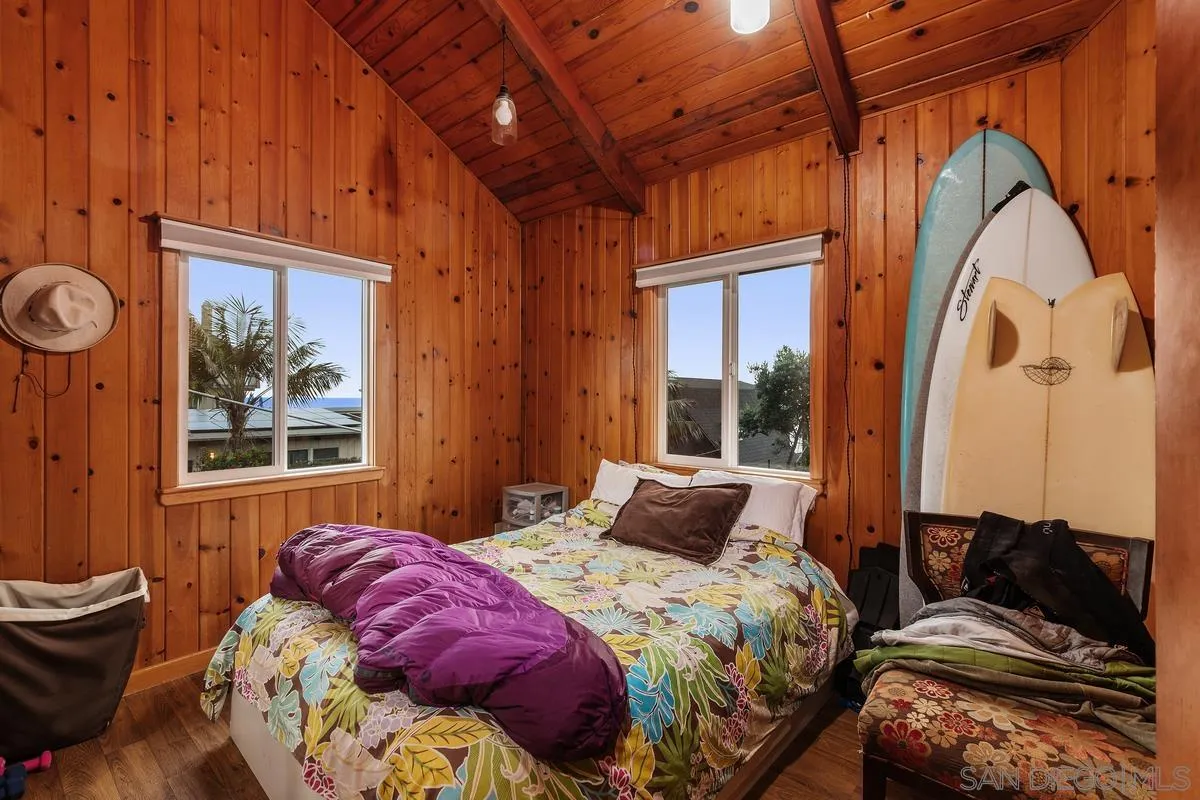 1366 Neptune Avenue Encinitas, CA 92024 - Photo 33 of 48 a bedroom with a bed and wooden floor