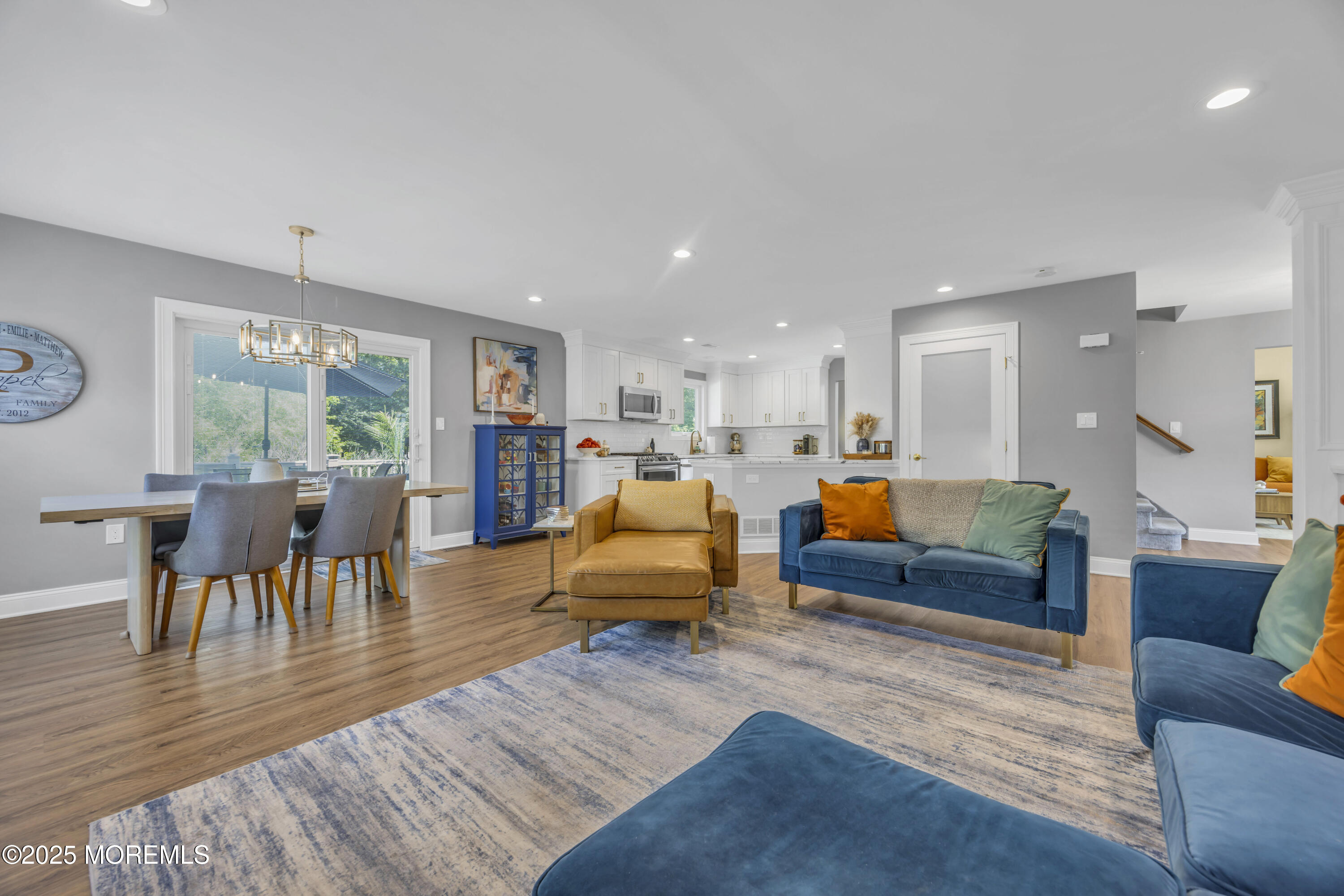50 Diamond Lane Howell, NJ 07731 - Photo 26 of 49 a living room with furniture and a dining table with wooden floor