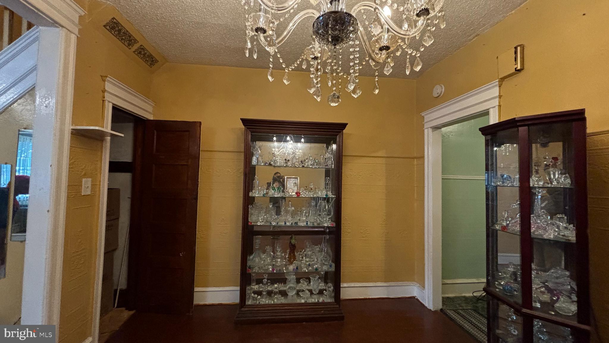 3017 North 26th Street Philadelphia, PA 19132 - Photo 7 of 26 a view of a hallway with wooden floor and a chandelier