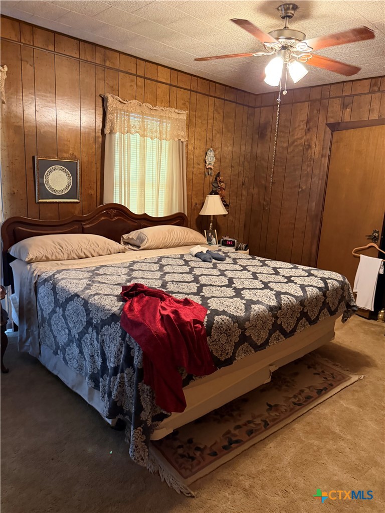 57 John Tillery Road Port Lavaca, TX 77979 - Photo 27 of 34 a bedroom with a bed and a chandelier