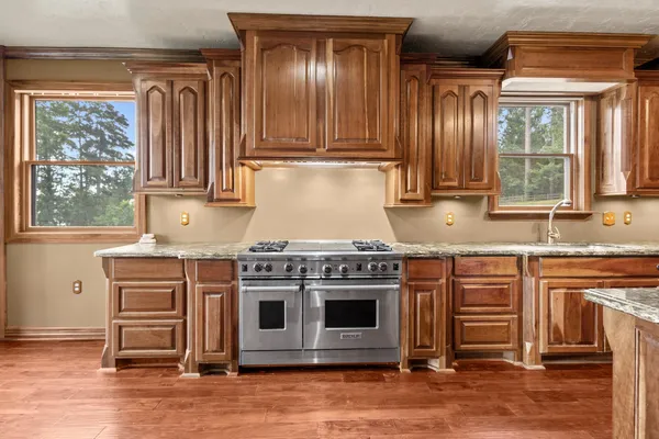 a kitchen with stainless steel appliances granite countertop a stove and a microwave