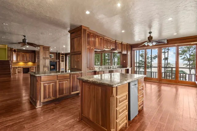 a kitchen with stainless steel appliances granite countertop a stove and cabinets