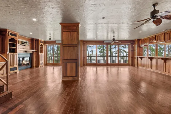 a view of a livingroom with furniture hardwood floor and staircase
