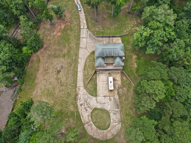 a view of a swimming pool with a yard