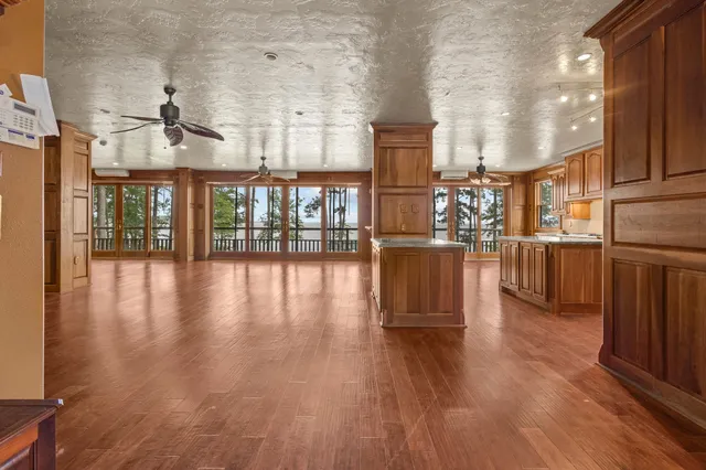 a view of a living room and kitchen with furniture and wooden floor