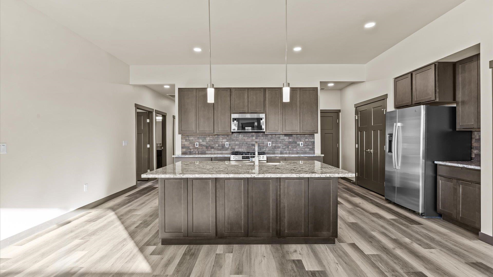 635 Anvil Way Grand Junction, CO 81504 - Photo 11 of 30 a kitchen with kitchen island a stove a refrigerator and a sink
