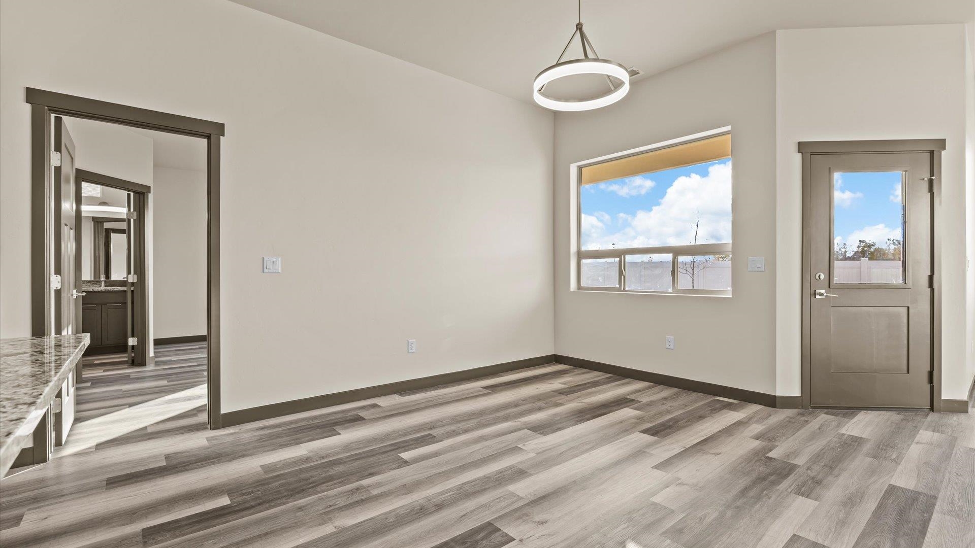 635 Anvil Way Grand Junction, CO 81504 - Photo 15 of 30 a view of an empty room with wooden floor and a window