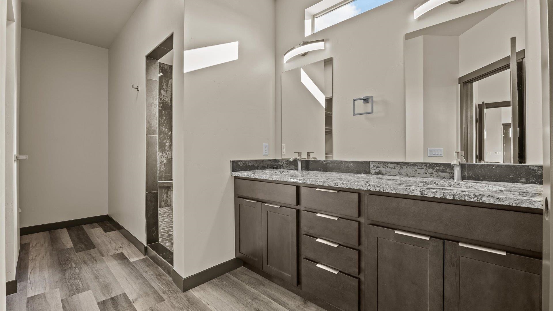 635 Anvil Way Grand Junction, CO 81504 - Photo 18 of 30 a bathroom with a granite countertop sink and a mirror