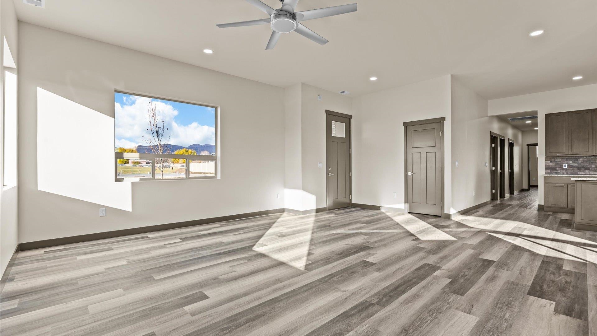 635 Anvil Way Grand Junction, CO 81504 - Photo 8 of 30 a view of a livingroom with wooden floor and a ceiling fan
