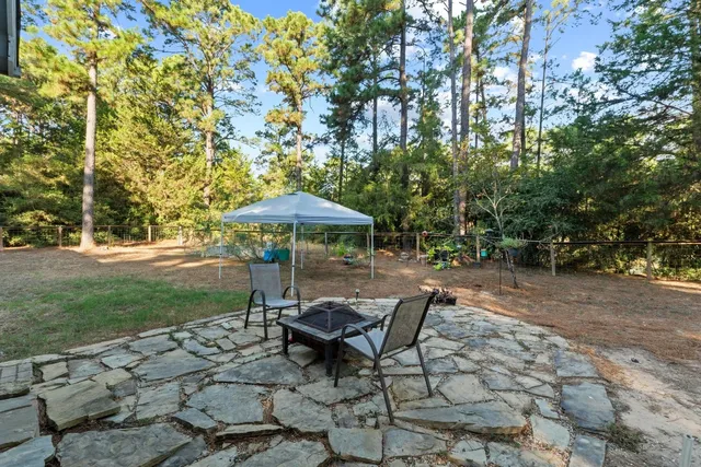 a swimming pool with outdoor seating and yard