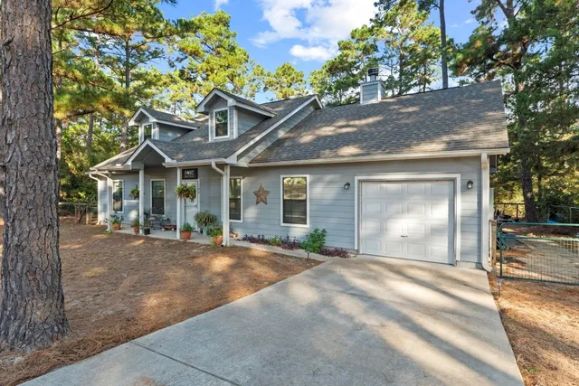 a front view of a house with a garden and yard