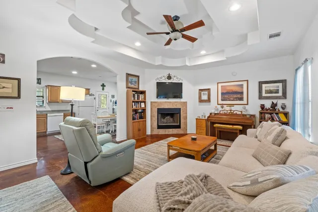 a living room with furniture kitchen view and a fireplace