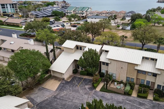 an aerial view of a house with garden space and street view